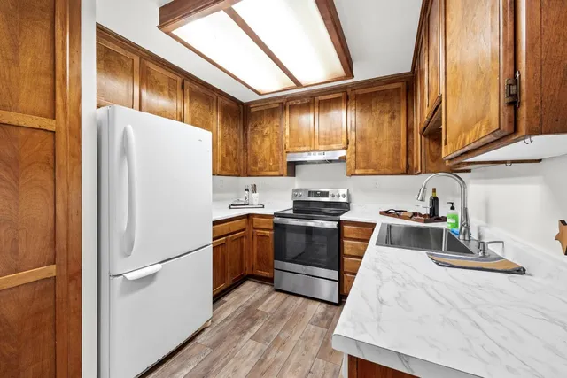 a kitchen with stainless steel appliances a refrigerator sink and cabinets