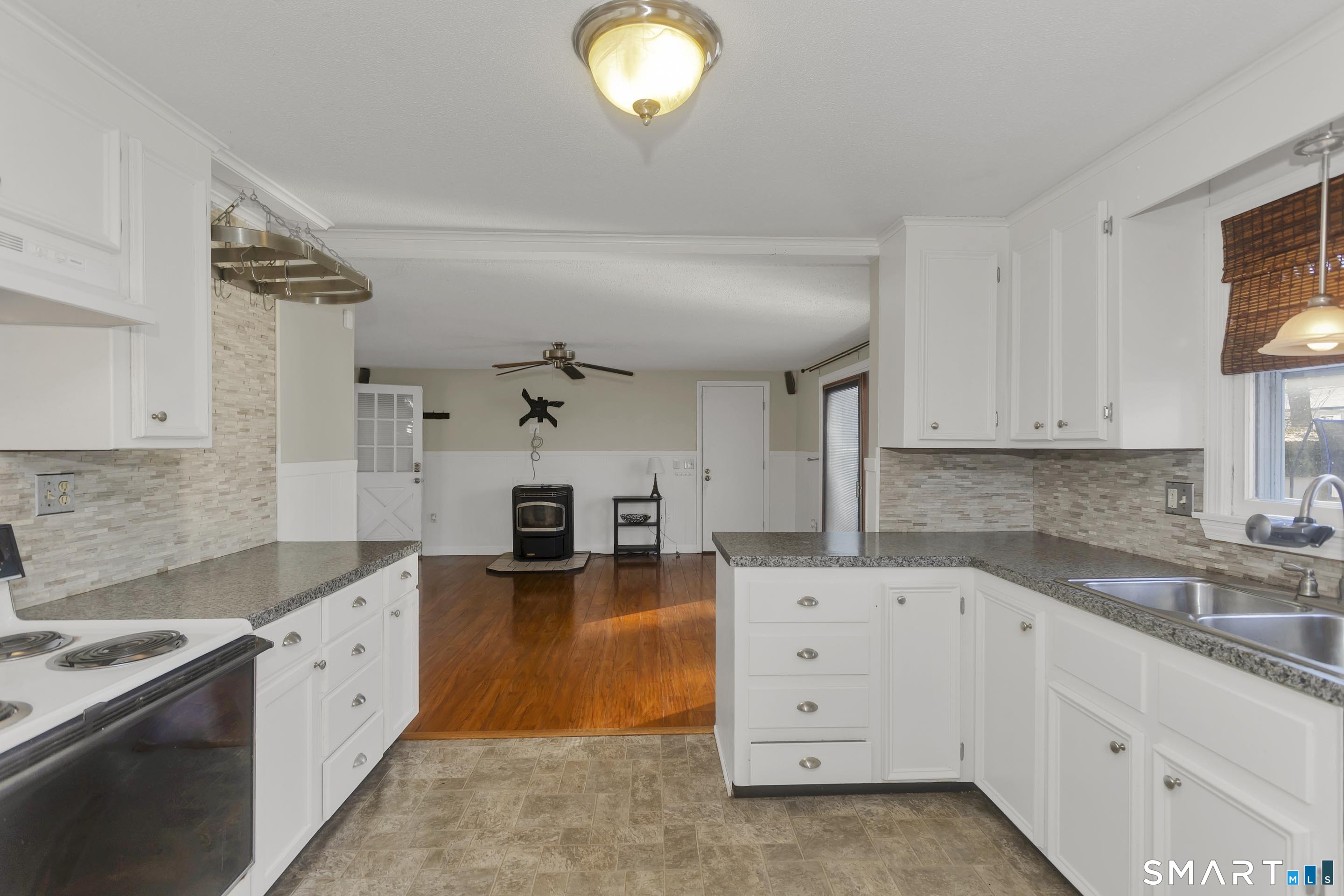 73 Laurel Street Enfield, CT 06082 - Photo 11 of 40 a large white kitchen with cabinets