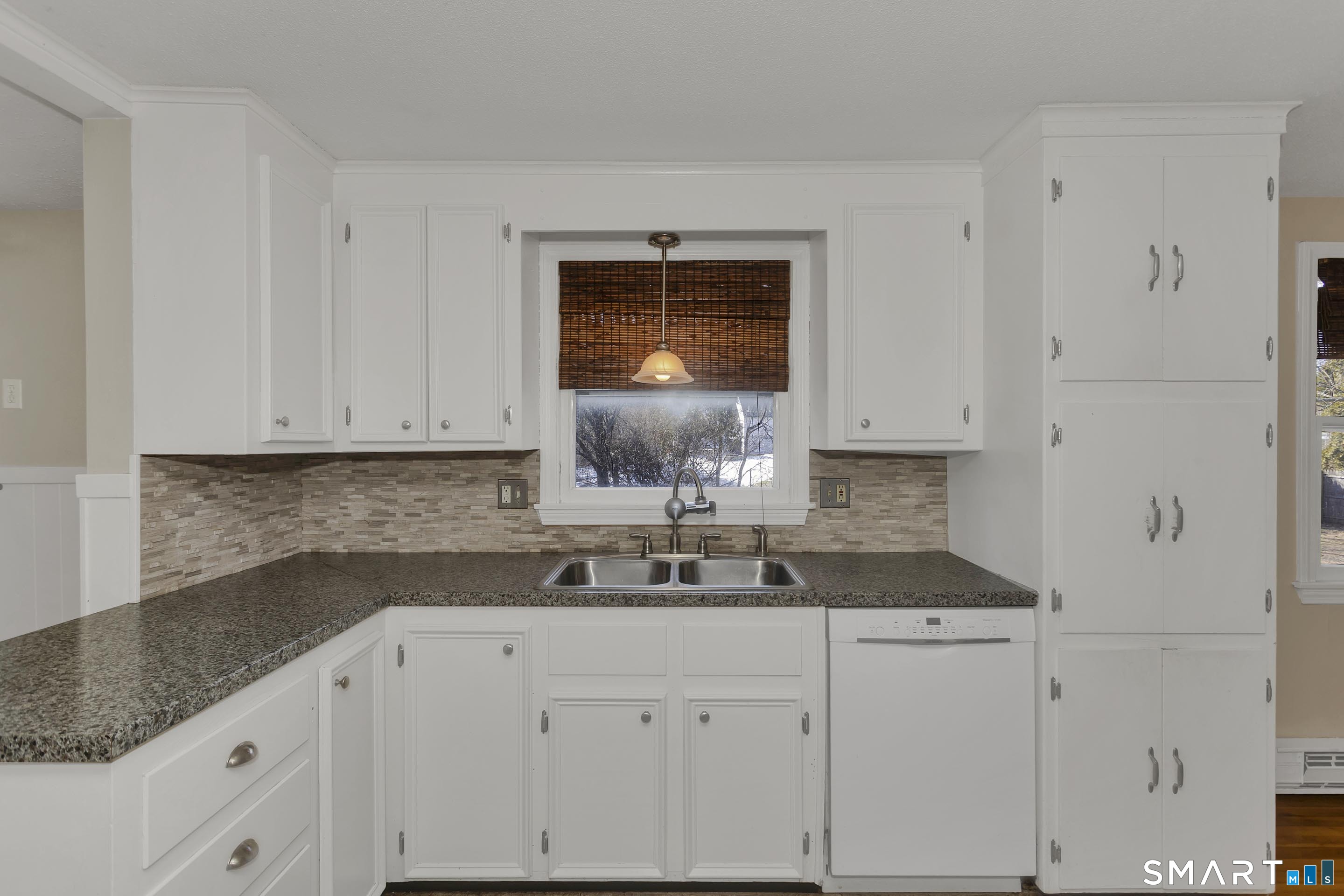 73 Laurel Street Enfield, CT 06082 - Photo 12 of 40 a kitchen with granite countertop white cabinets and a sink