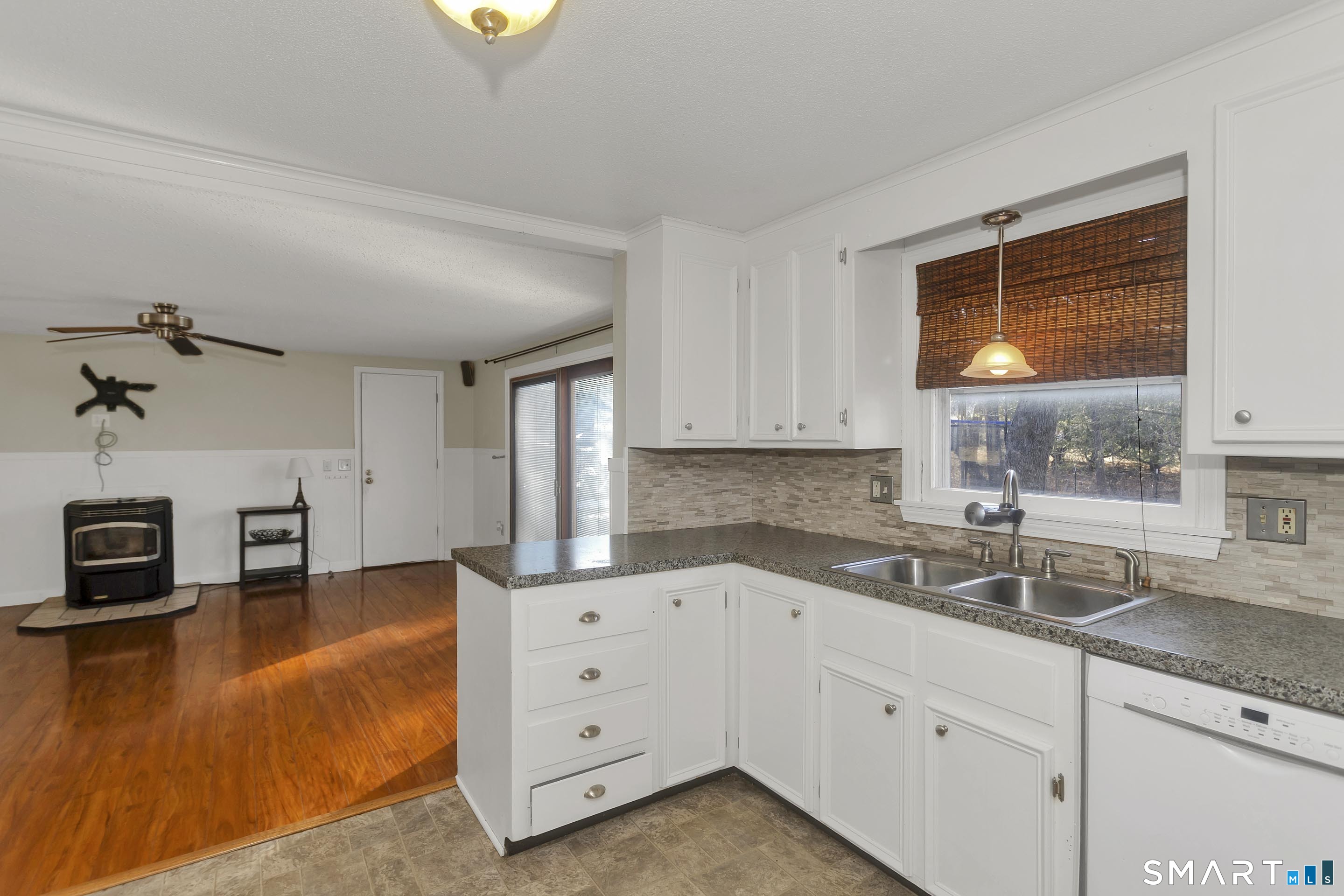 73 Laurel Street Enfield, CT 06082 - Photo 13 of 40 a kitchen with granite countertop a sink cabinets and window