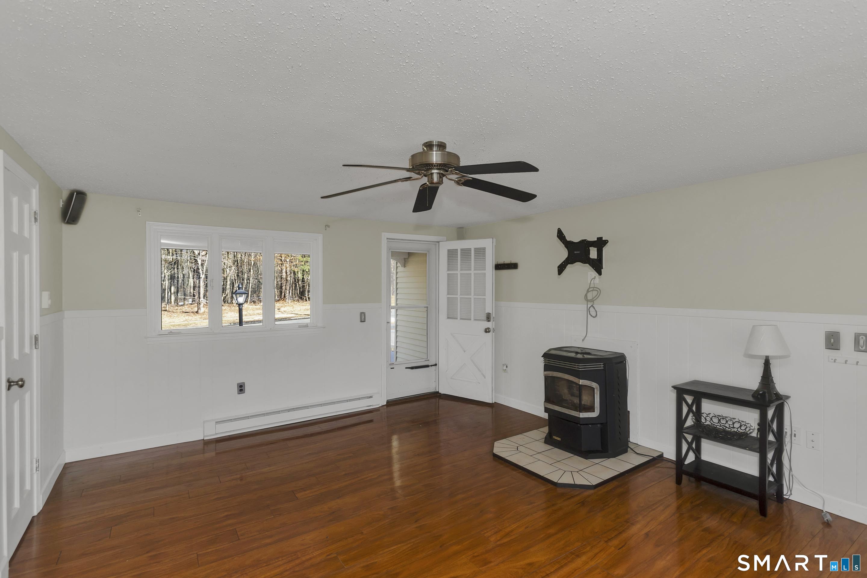 73 Laurel Street Enfield, CT 06082 - Photo 14 of 40 a view of an empty room with a window and wooden floor
