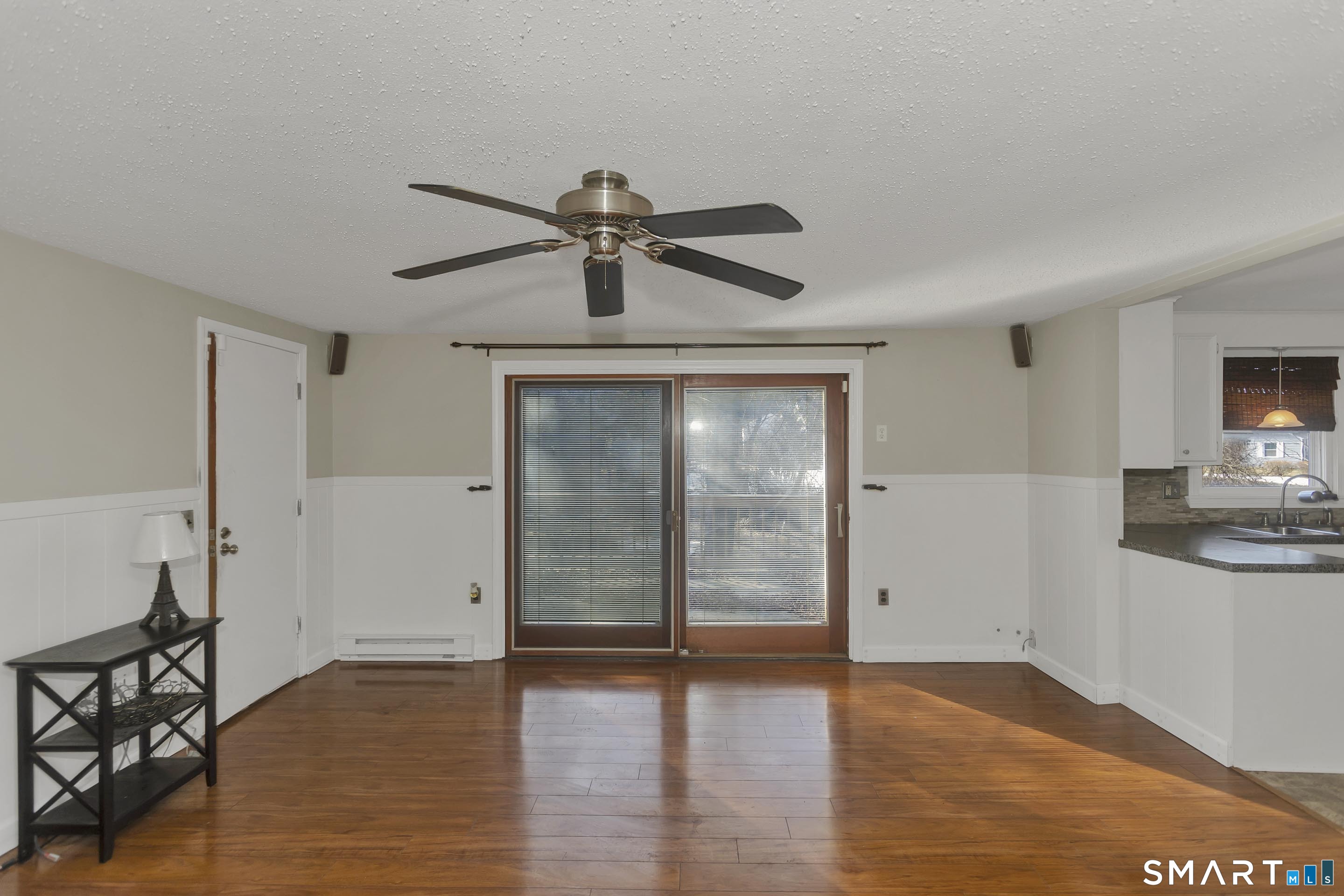 73 Laurel Street Enfield, CT 06082 - Photo 18 of 40 a view of a livingroom with a ceiling fan & hardwood floor