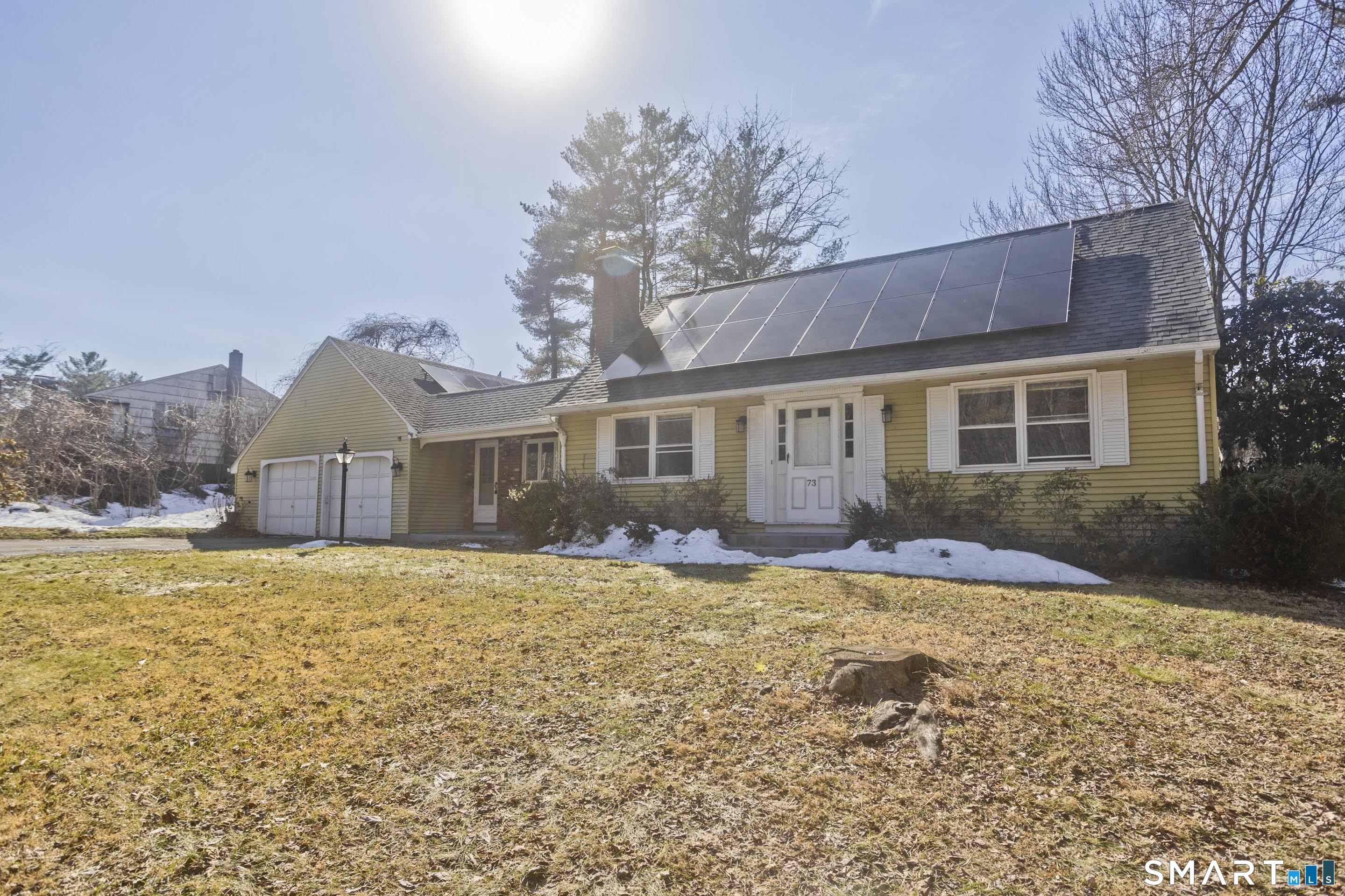 73 Laurel Street Enfield, CT 06082 - Photo 2 of 40 a front view of a house with a yard and garage