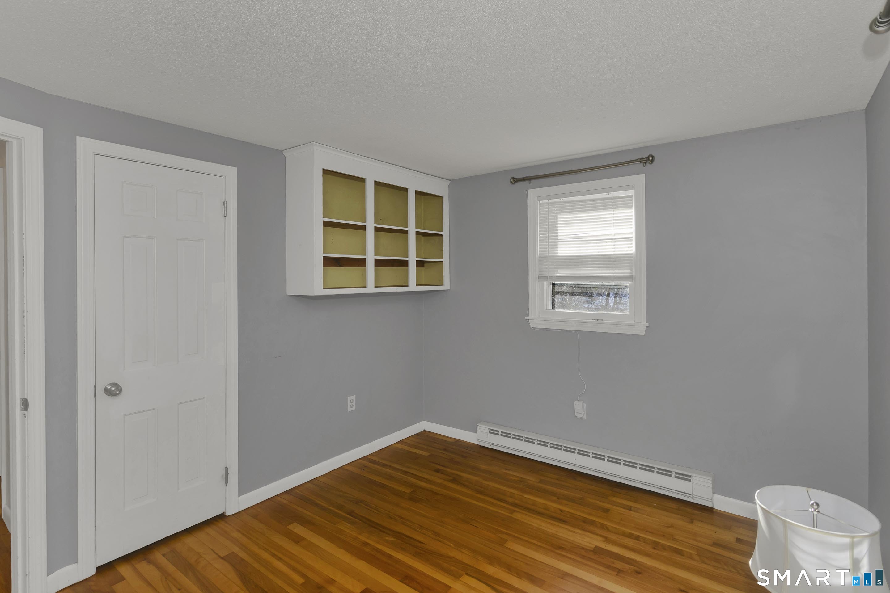 73 Laurel Street Enfield, CT 06082 - Photo 21 of 40 a room with a wooden floor and a window