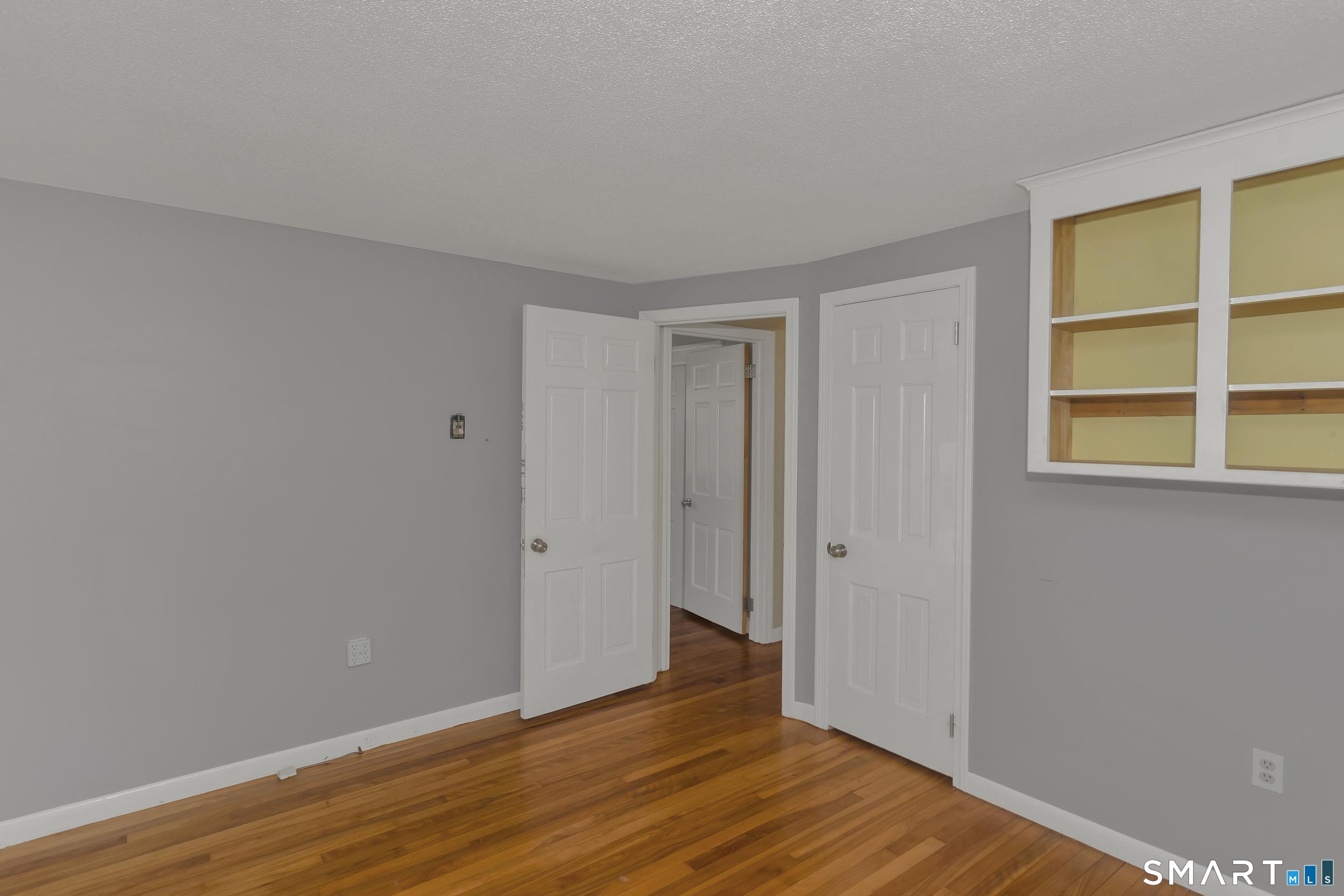 73 Laurel Street Enfield, CT 06082 - Photo 22 of 40 a view of an empty room with wooden floor and a window