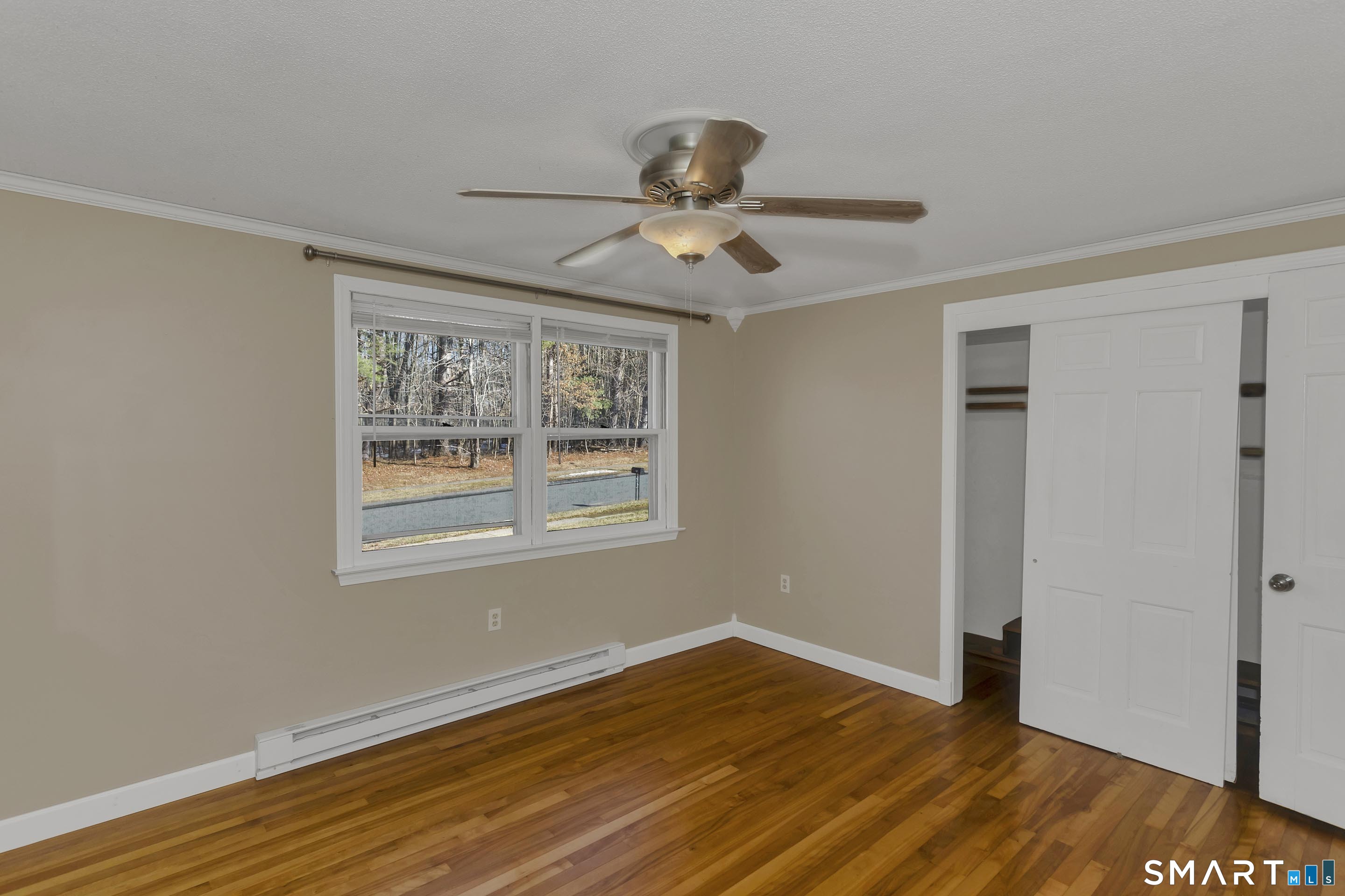 73 Laurel Street Enfield, CT 06082 - Photo 24 of 40 a view of an empty room with wooden floor and a window