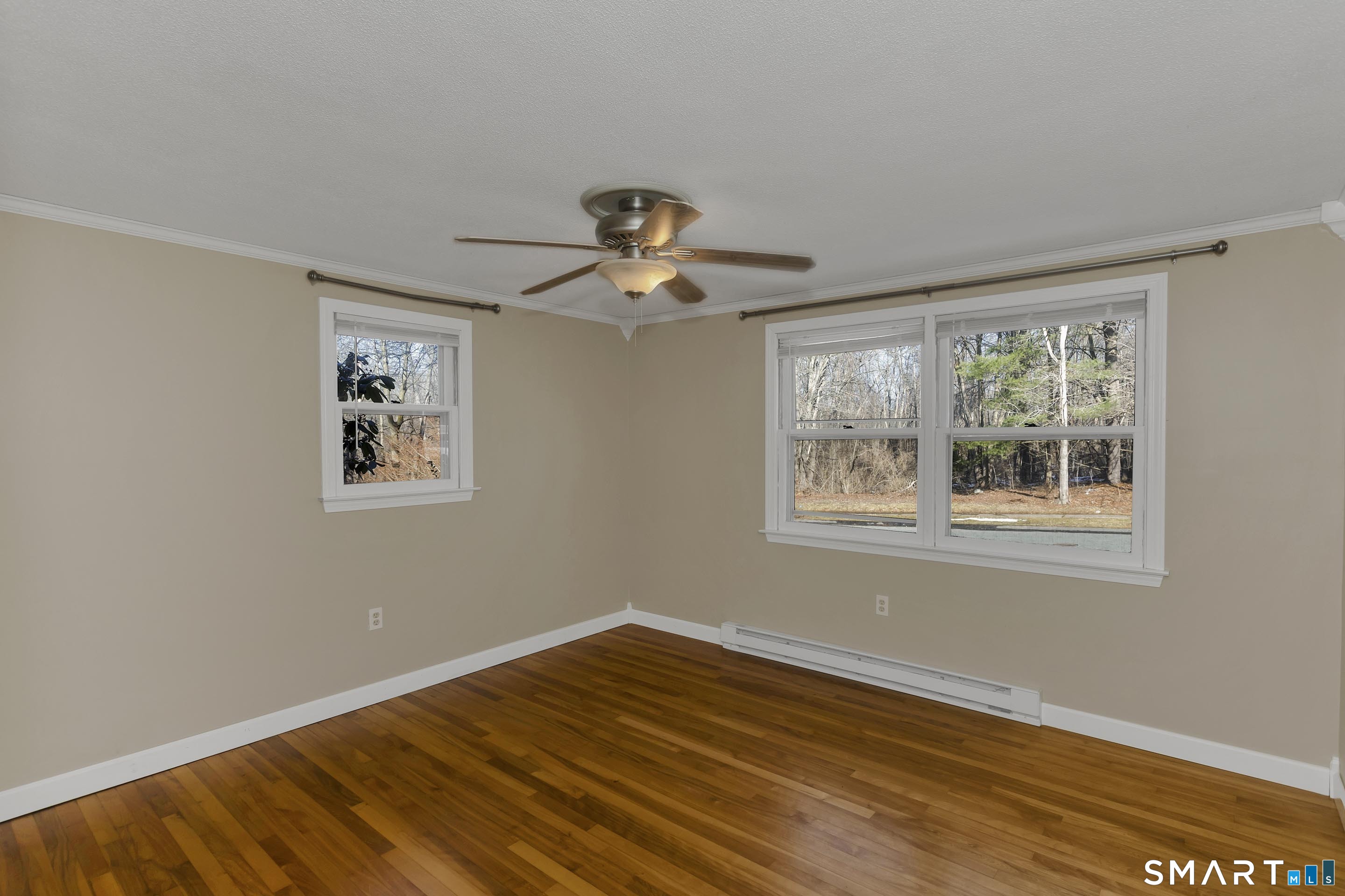 73 Laurel Street Enfield, CT 06082 - Photo 25 of 40 a view of empty room with wooden floor and fan
