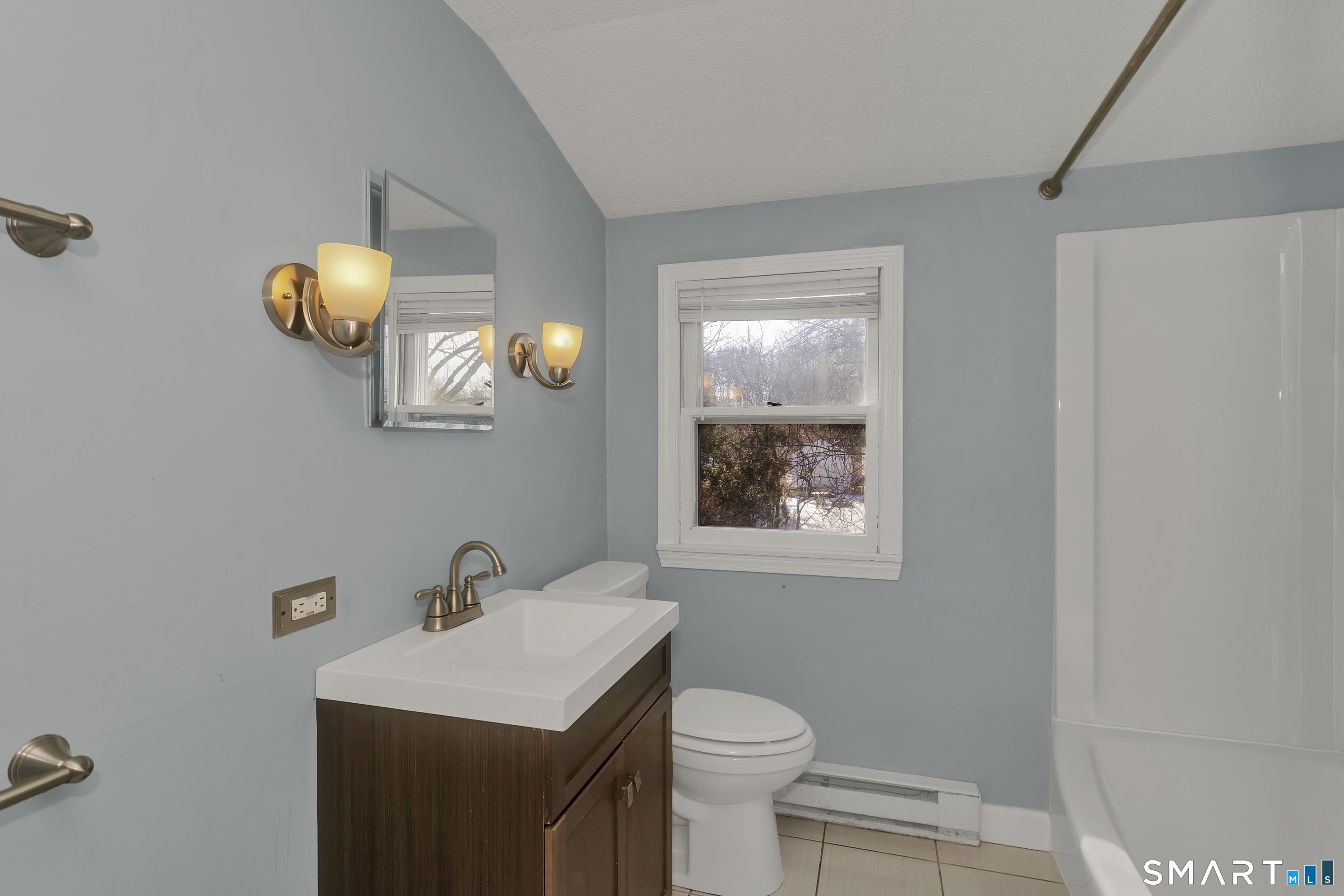 73 Laurel Street Enfield, CT 06082 - Photo 29 of 40 a bathroom with a toilet a sink and mirror