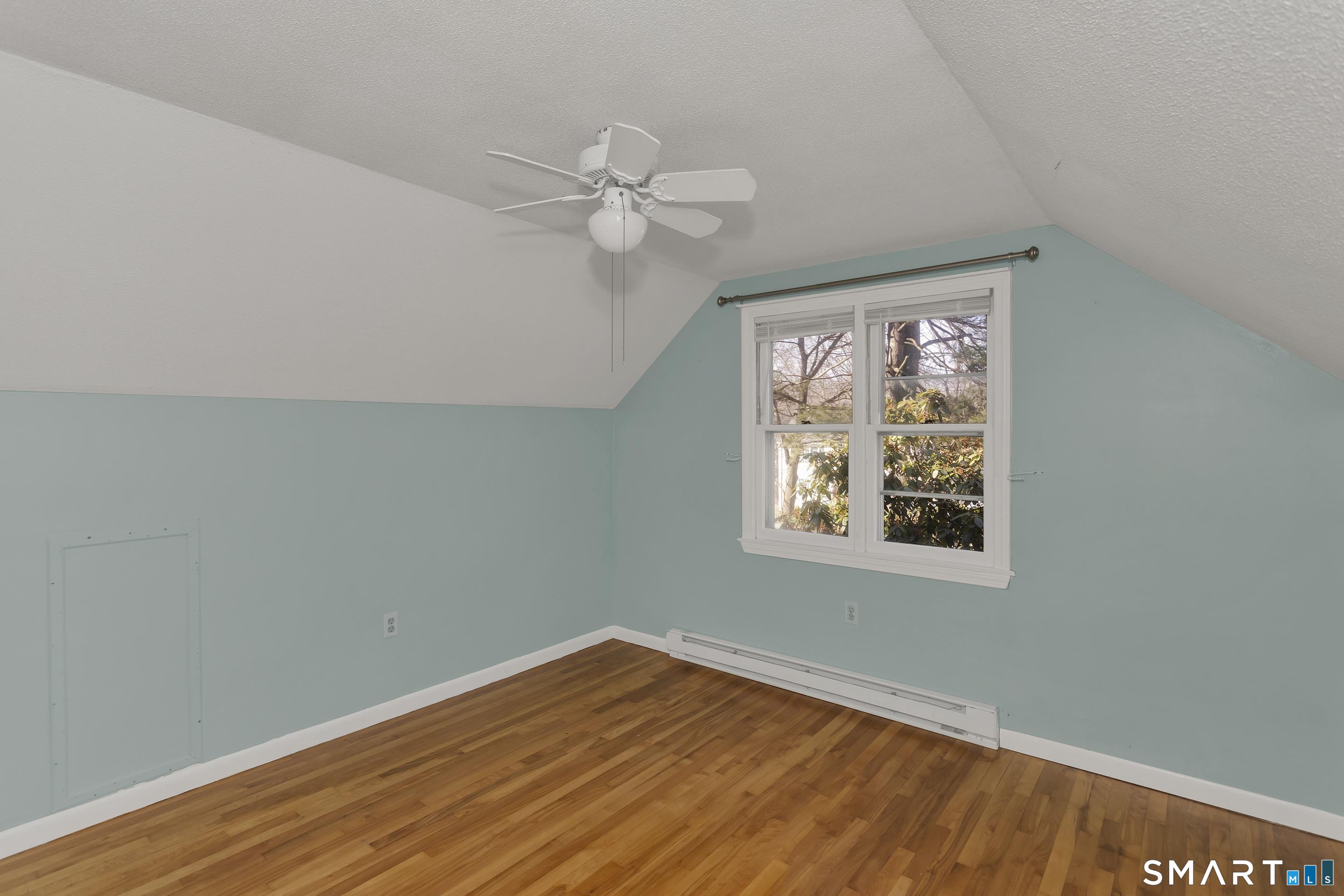 73 Laurel Street Enfield, CT 06082 - Photo 31 of 40 a view of an empty room with wooden floor and a window
