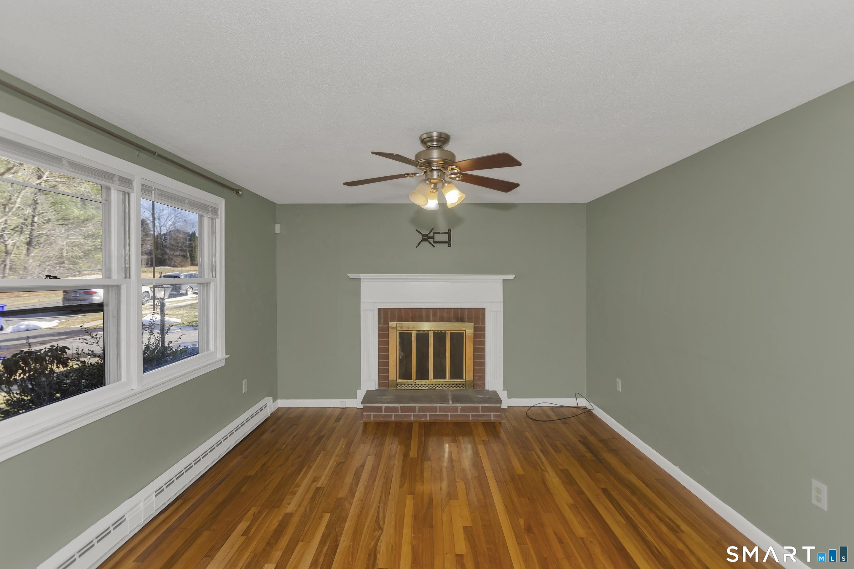 73 Laurel Street Enfield, CT 06082 - Photo 5 of 40 a view of empty room with wooden floor and fan