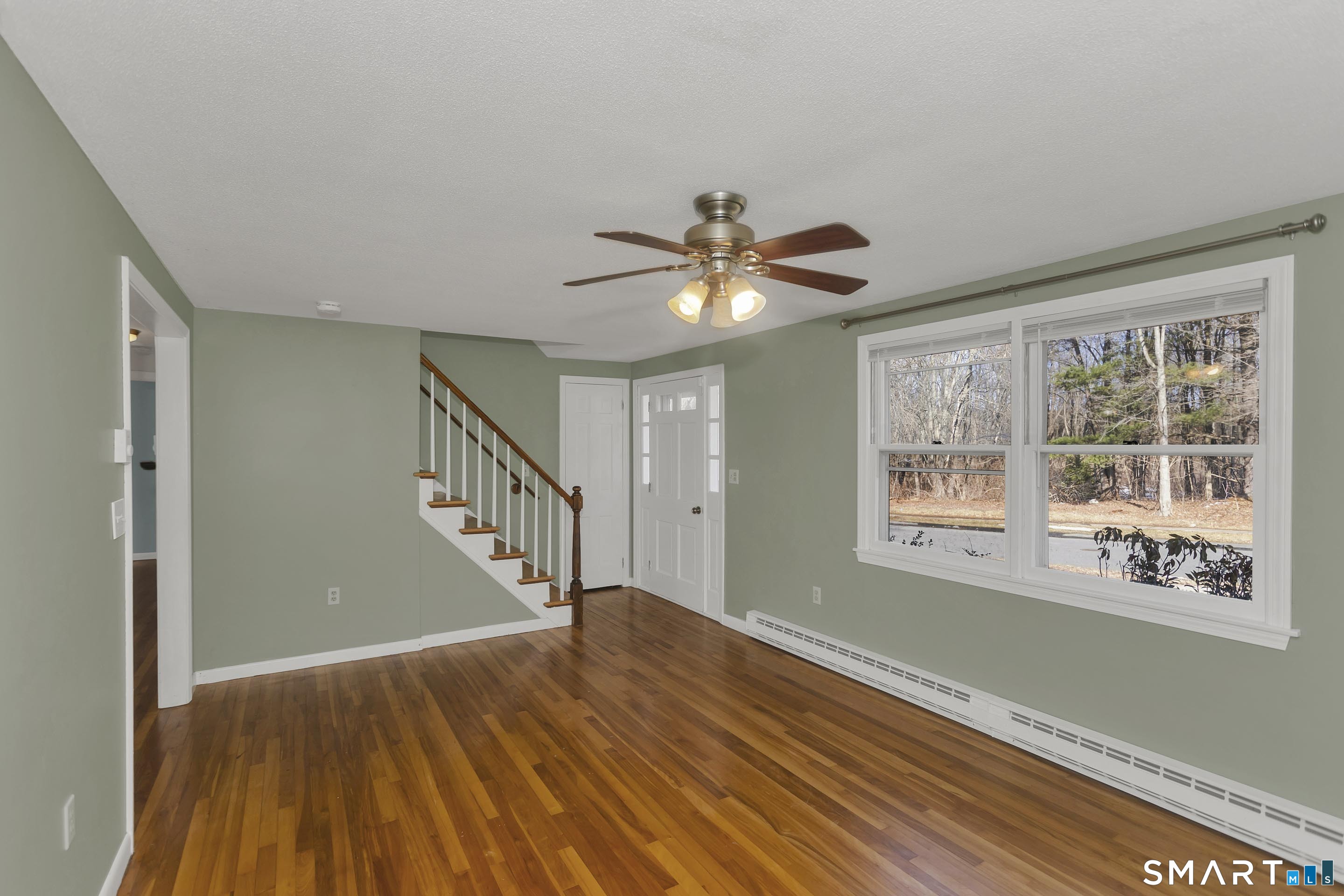 73 Laurel Street Enfield, CT 06082 - Photo 7 of 40 a view of an empty room with wooden floor and a window