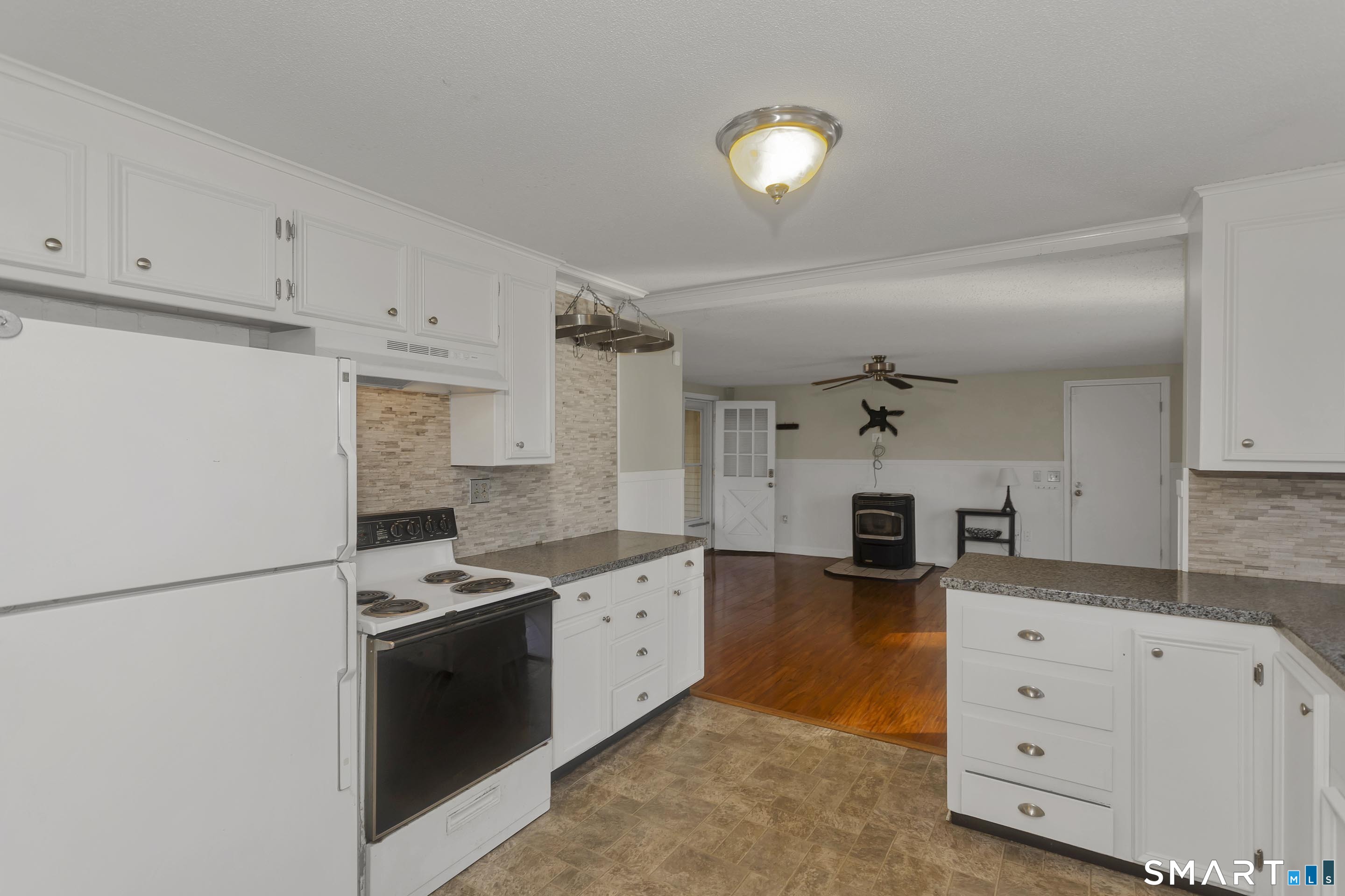 73 Laurel Street Enfield, CT 06082 - Photo 10 of 40 a kitchen with white cabinets and white appliances