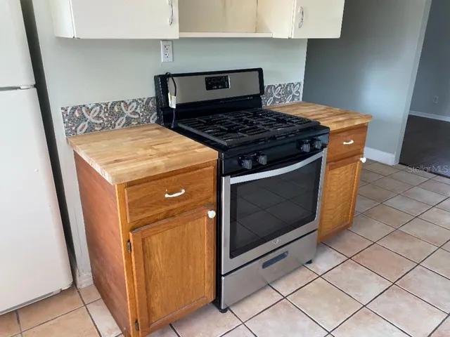 a stove top oven sitting inside of a kitchen