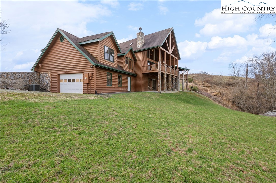 460 Deer Crossing Road Piney Creek, NC 28663 - Photo 11 of 29 a front view of a house with a garden and yard