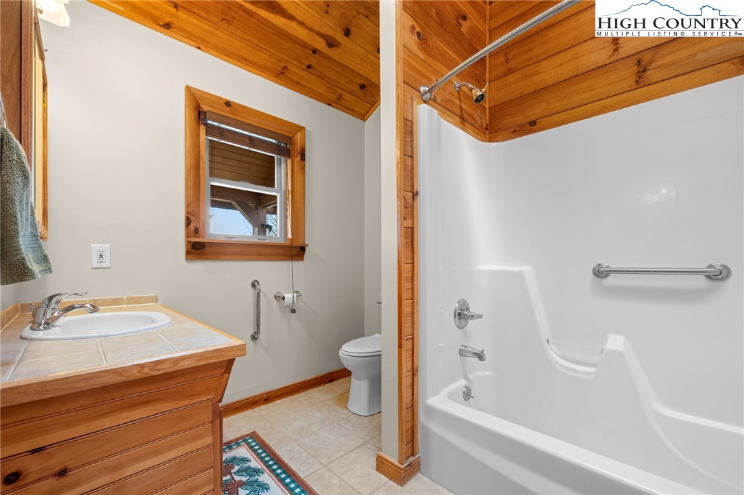 460 Deer Crossing Road Piney Creek, NC 28663 - Photo 14 of 29 a bathroom with a sink and a bathtub