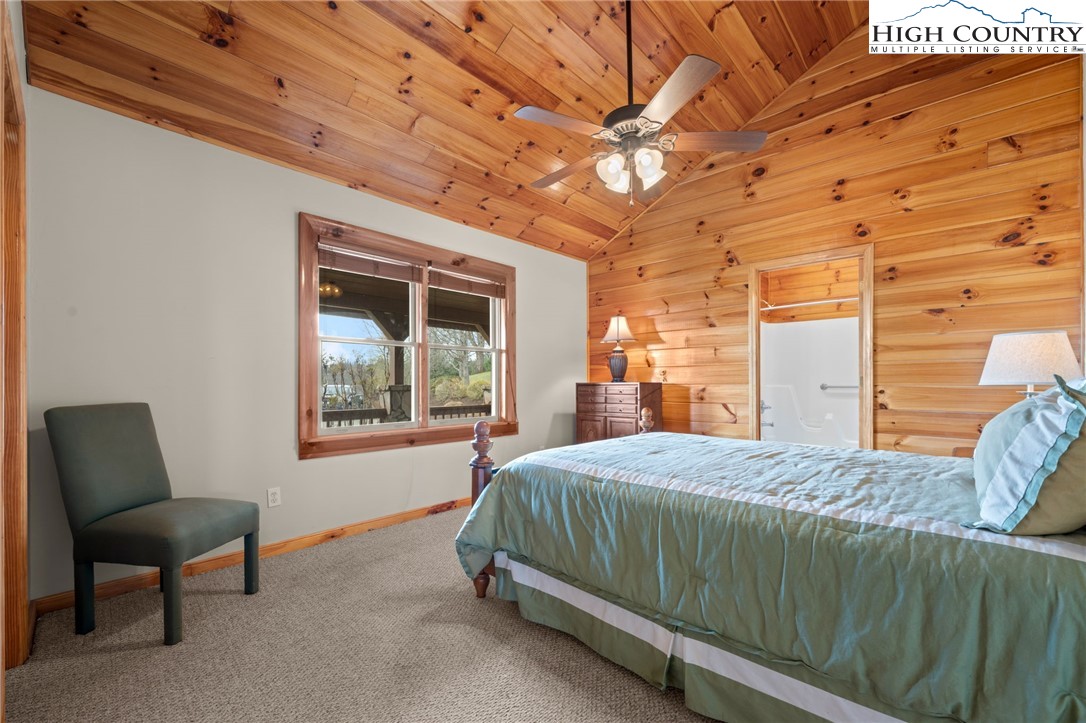 460 Deer Crossing Road Piney Creek, NC 28663 - Photo 15 of 29 a bedroom with a bed chair and a window