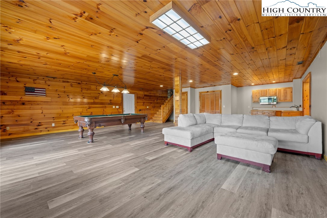 460 Deer Crossing Road Piney Creek, NC 28663 - Photo 17 of 29 a living room with couches and kitchen view with wooden floor