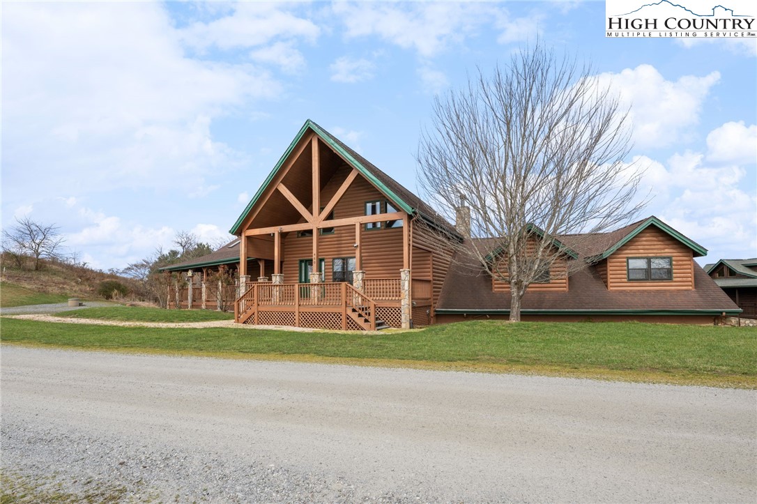 460 Deer Crossing Road Piney Creek, NC 28663 - Photo 19 of 29 a front view of a house with a yard and garage