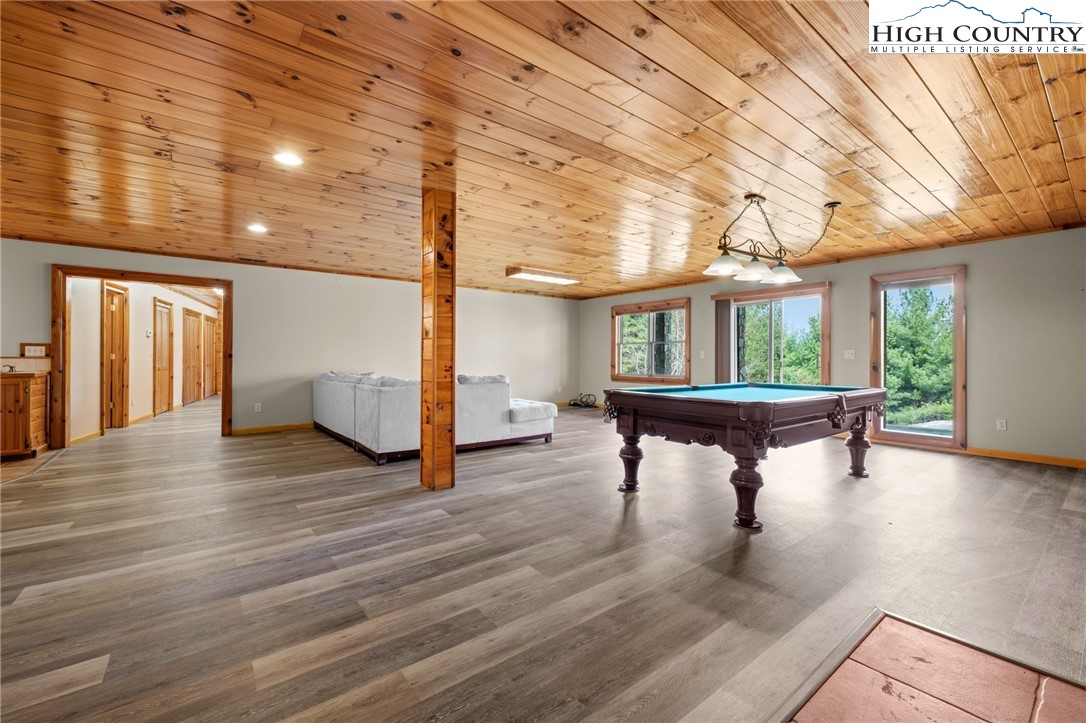 460 Deer Crossing Road Piney Creek, NC 28663 - Photo 20 of 29 a view of a room with wooden floor and chair