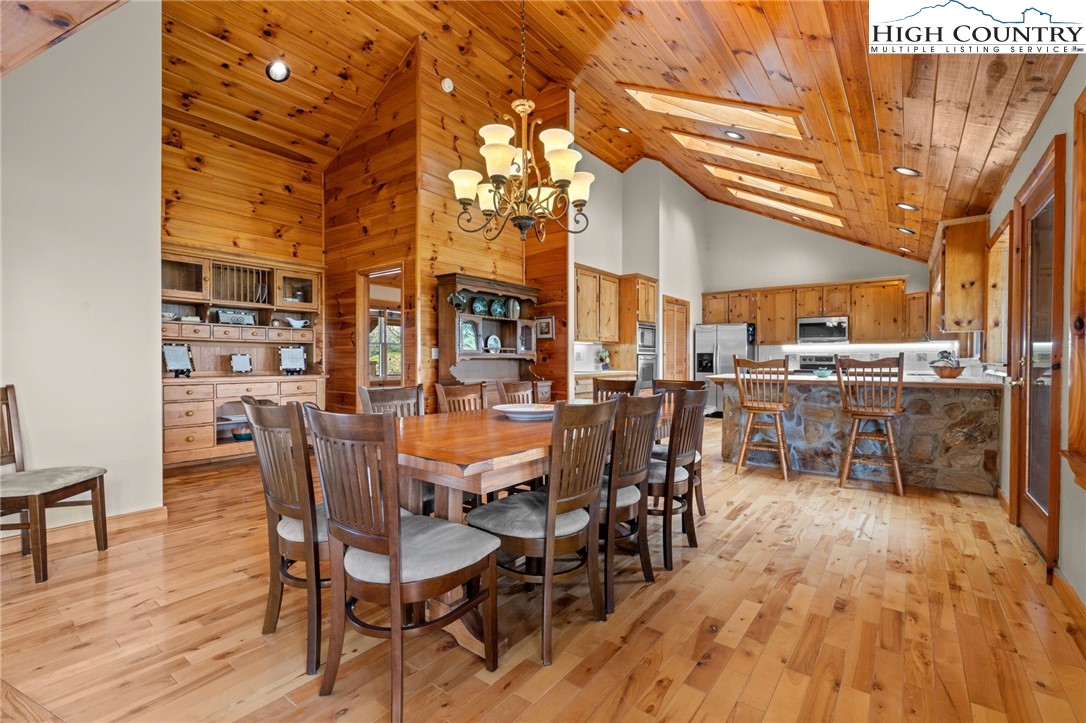 460 Deer Crossing Road Piney Creek, NC 28663 - Photo 2 of 29 a view of a dining room with furniture and wooden floor