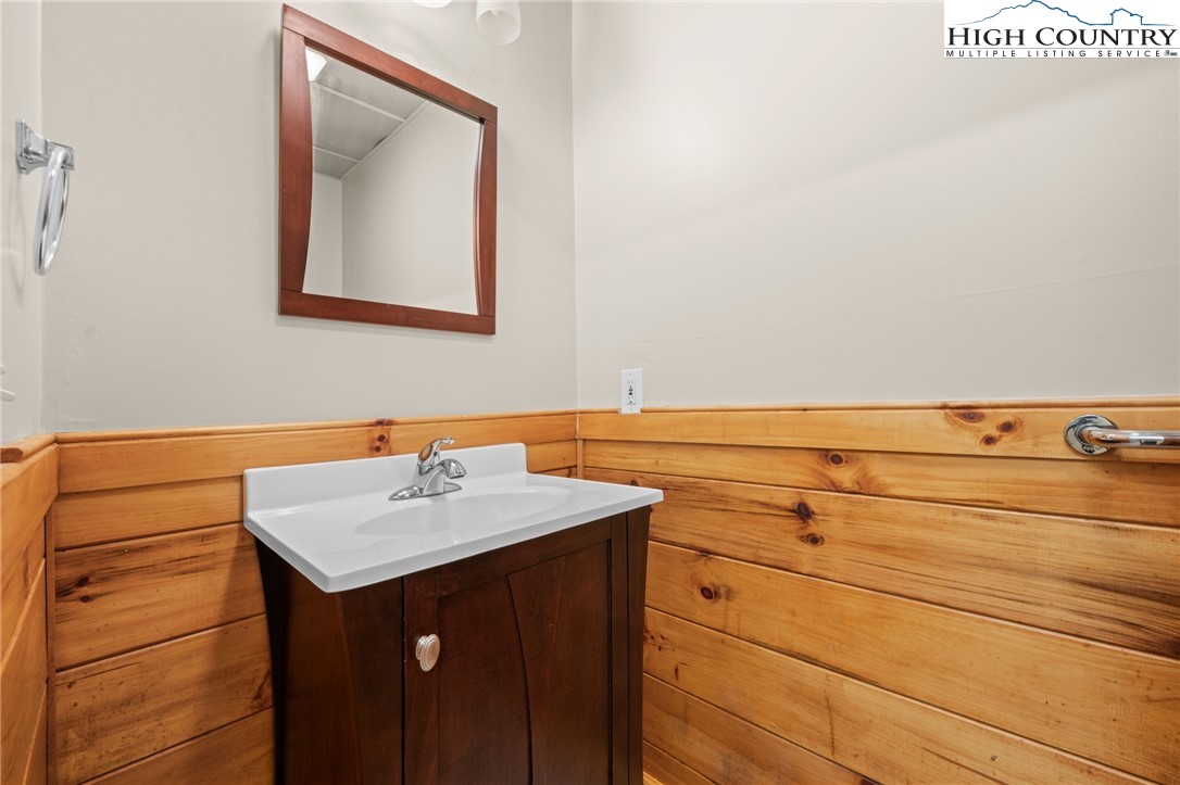 460 Deer Crossing Road Piney Creek, NC 28663 - Photo 22 of 29 a bathroom with a sink and a mirror