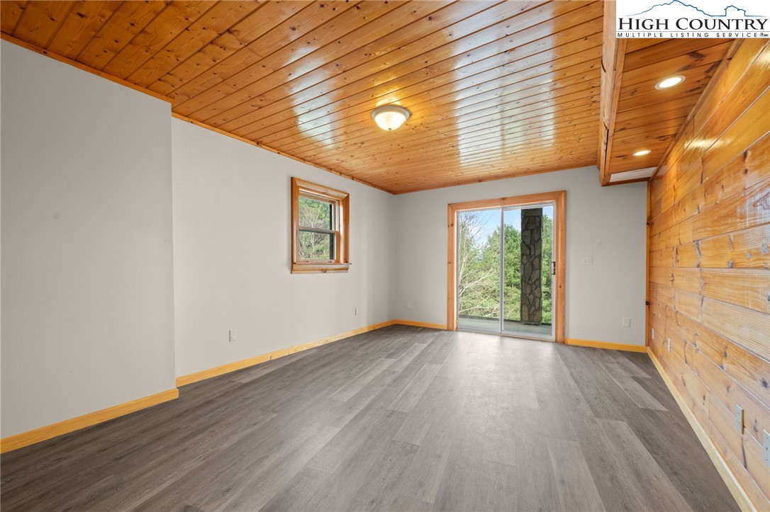 460 Deer Crossing Road Piney Creek, NC 28663 - Photo 26 of 29 a view of an empty room with wooden floor and a window