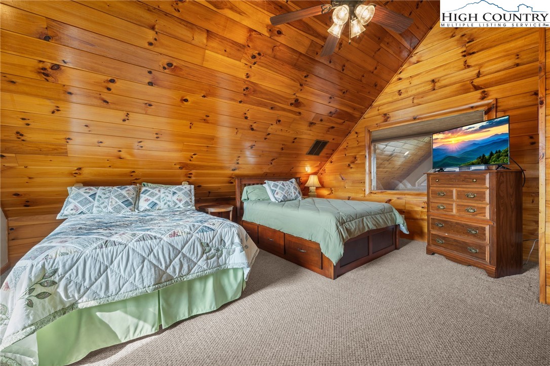 460 Deer Crossing Road Piney Creek, NC 28663 - Photo 28 of 29 a bedroom with a bed and a night stand