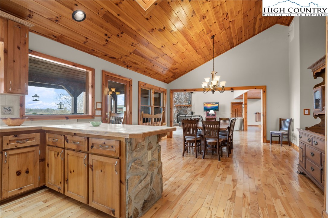 460 Deer Crossing Road Piney Creek, NC 28663 - Photo 3 of 29 a view of a dining room with furniture and chandelier