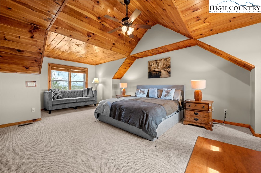 460 Deer Crossing Road Piney Creek, NC 28663 - Photo 9 of 29 a bedroom with a bed and wooden floor