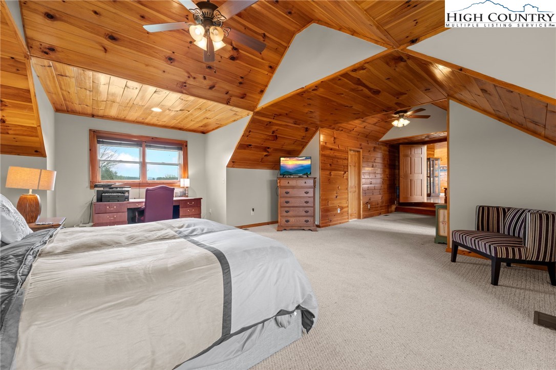 460 Deer Crossing Road Piney Creek, NC 28663 - Photo 10 of 29 a bed room with a bed and a chair