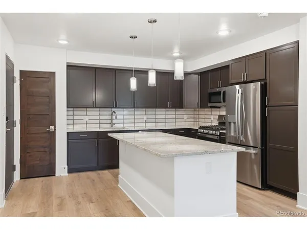 a kitchen with a refrigerator and a sink