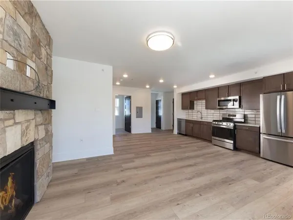 a large kitchen with kitchen island a sink stainless steel appliances and cabinets