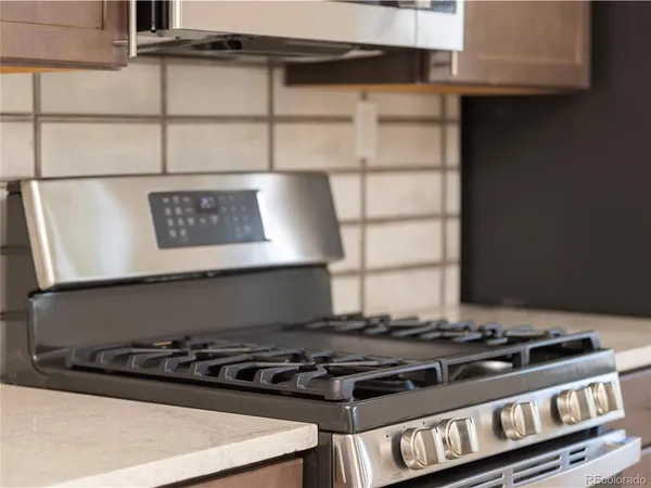a stove top oven sitting inside of a kitchen