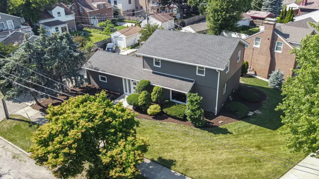 an aerial view of a house with yard