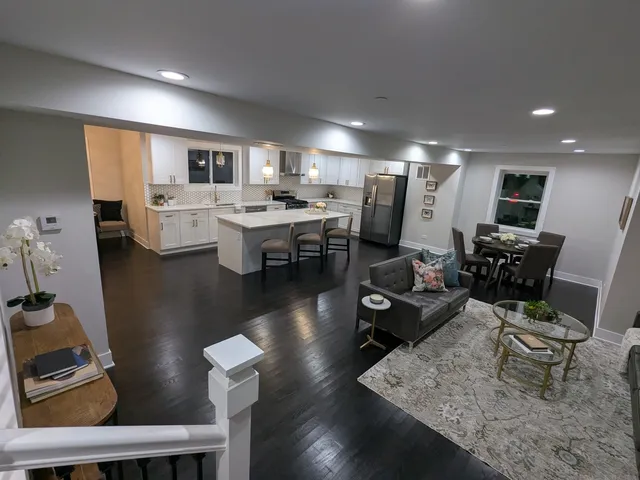 a living room with lots of furniture and view of kitchen