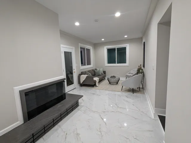 a living room with furniture a window and a fireplace