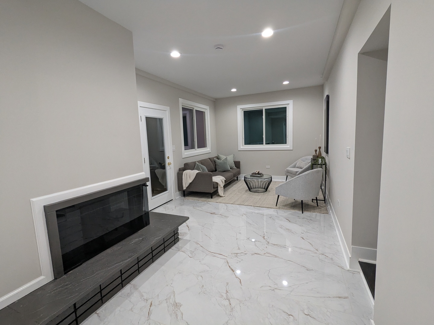 8600 East Prairie Road Skokie, IL 60076 - Photo 19 of 37 a living room with furniture a window and a fireplace