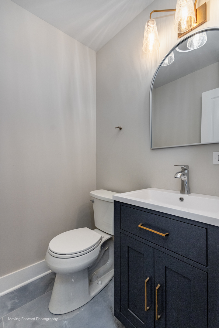 8600 East Prairie Road Skokie, IL 60076 - Photo 22 of 37 a bathroom with a toilet a sink and mirror