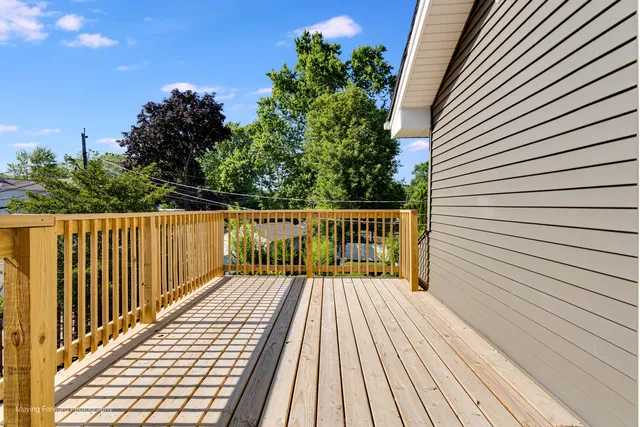 a view of wooden balcony and trees