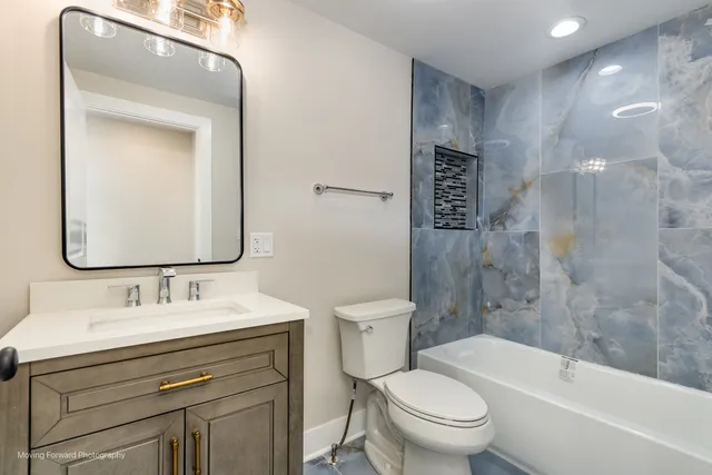 a bathroom with a sink toilet and shower