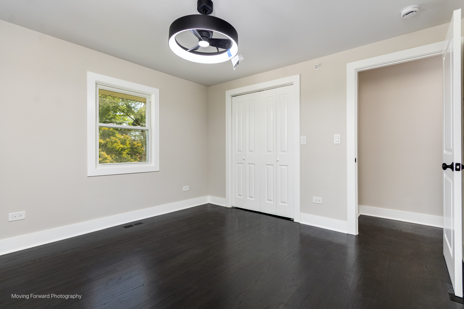 8600 East Prairie Road Skokie, IL 60076 - Photo 27 of 37 an empty room with wooden floor and windows