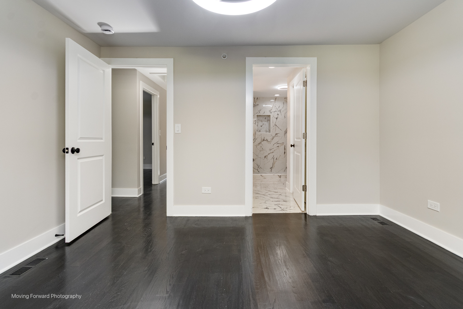 8600 East Prairie Road Skokie, IL 60076 - Photo 30 of 37 an empty room with wooden floor and windows