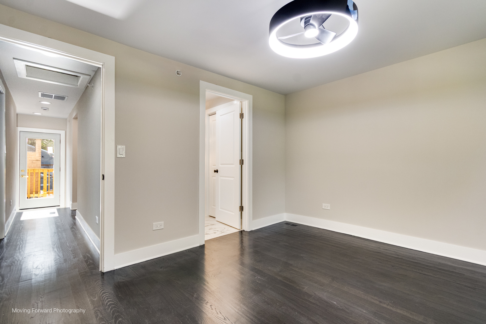 8600 East Prairie Road Skokie, IL 60076 - Photo 31 of 37 an empty room with wooden floor cabinet and windows
