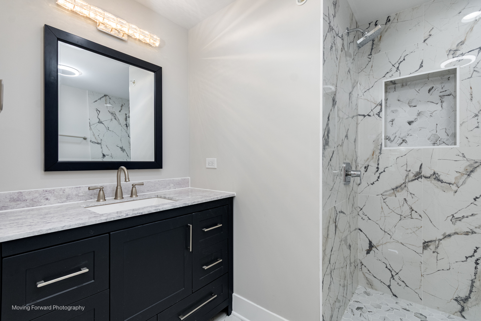 8600 East Prairie Road Skokie, IL 60076 - Photo 32 of 37 a bathroom with a sink vanity and a mirror