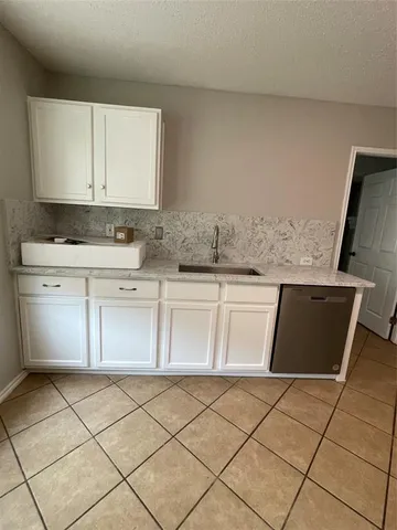 a kitchen with a sink and cabinets