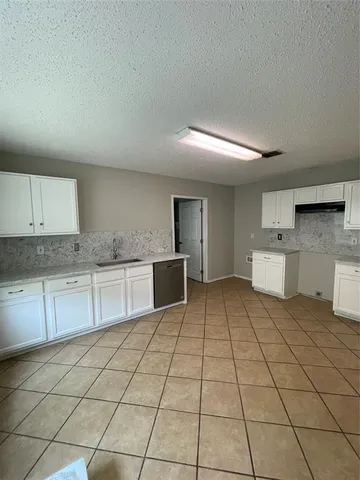 a kitchen with stainless steel appliances a sink and cabinets