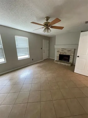 a view of an empty room with a fireplace