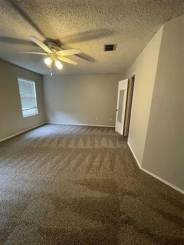 en empty room with windows and entrance