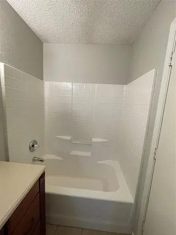 a bathroom with a bathtub and a sink