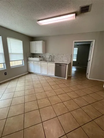 a kitchen with stainless steel appliances a sink and cabinets